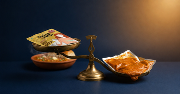 Freeze dried vs retort pouch comparison showing a 70g freeze dried Indian meal packet beside a heavier wet retort pouch