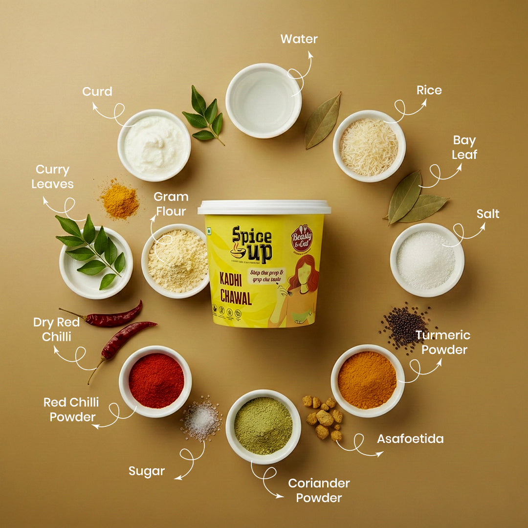 Spice Up Kadi Chawal packaging surrounded by ingredients on a brown background