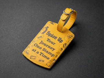 Yellow luggage tag with text and graphics on a dark gray background
