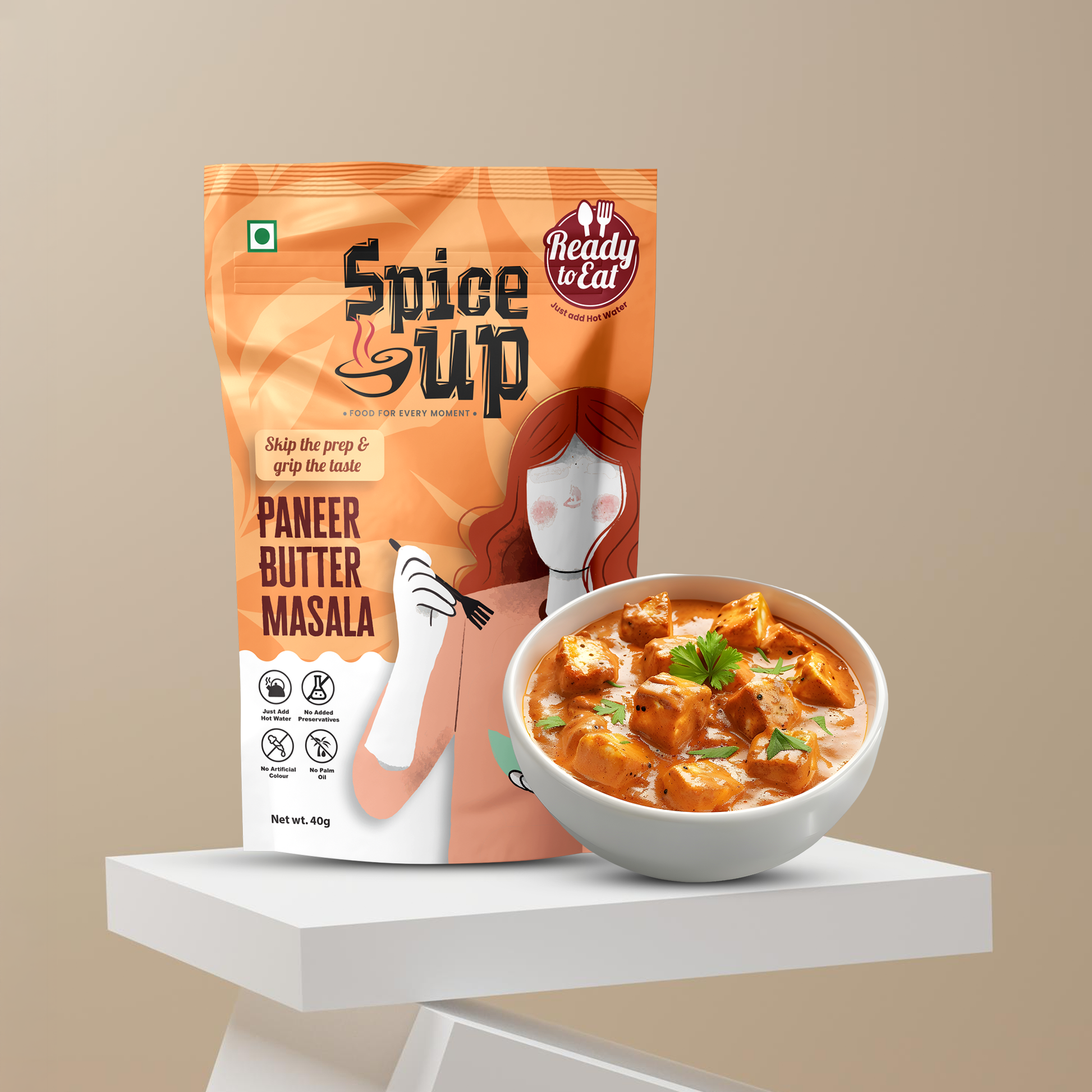 Spice Up Paneer Butter Masala packaging with a bowl of food on a beige background